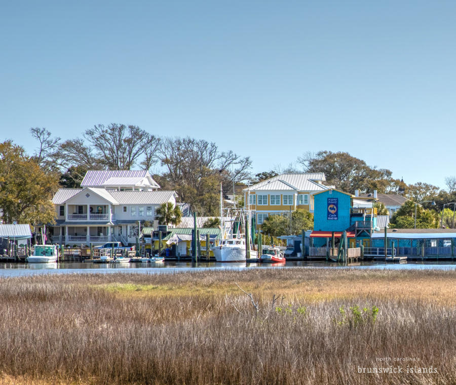a view of homes and restaurants in Southport's yacht basin in the offseason