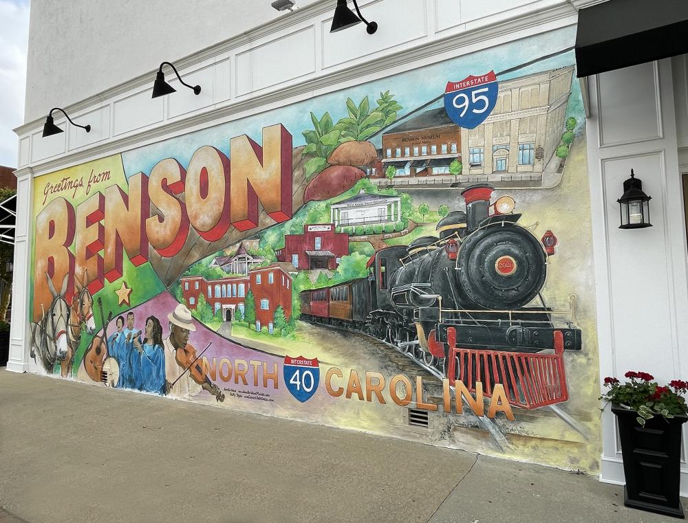 Artists working the mural; it looks like a postcard sent from Benson.