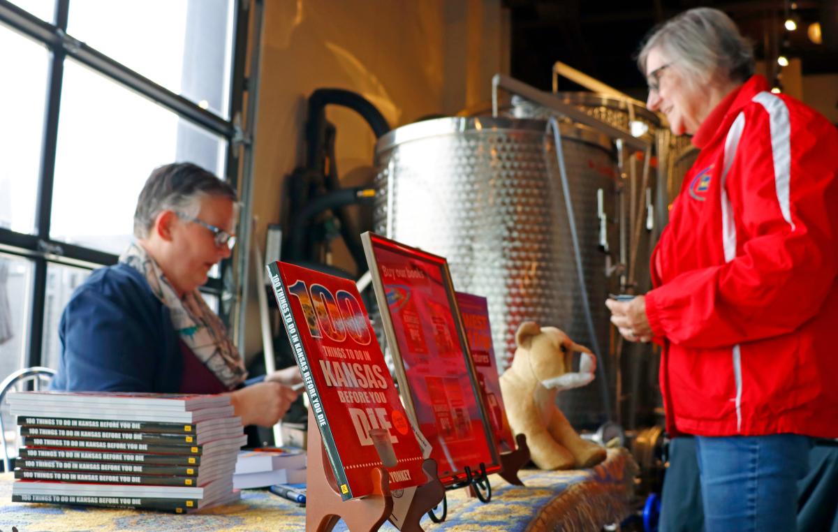 A photo of a book signing for 100 Things To Do in Kansas Before You Die