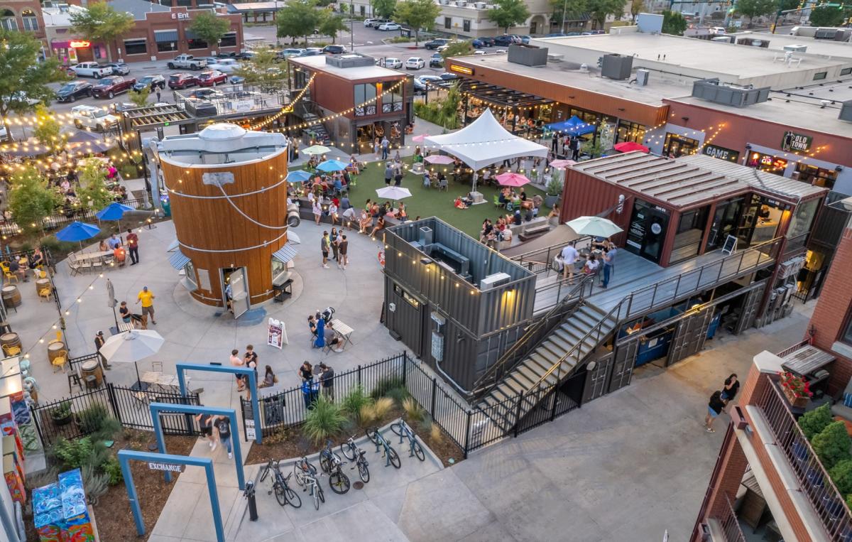 An areal shot of a community gathering space with shipping containers as the stores.