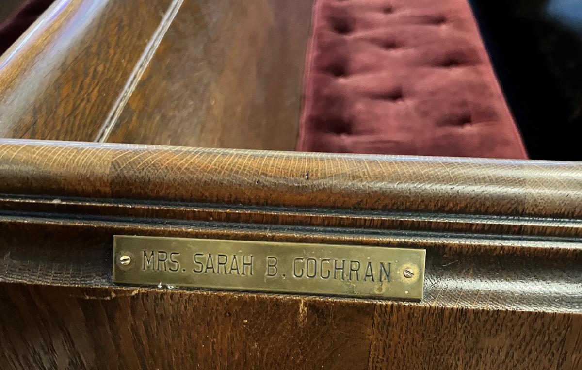 A nameplate marks the pew where Sarah B. Cochran regularly sat at Phillip G. Cochran Memorial United Methodist Church in Dawason.