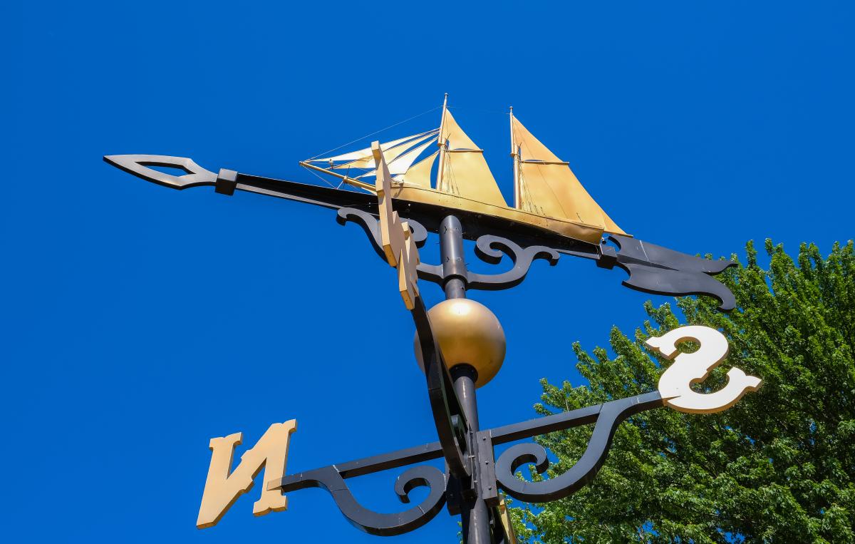 weathervane and blue skies