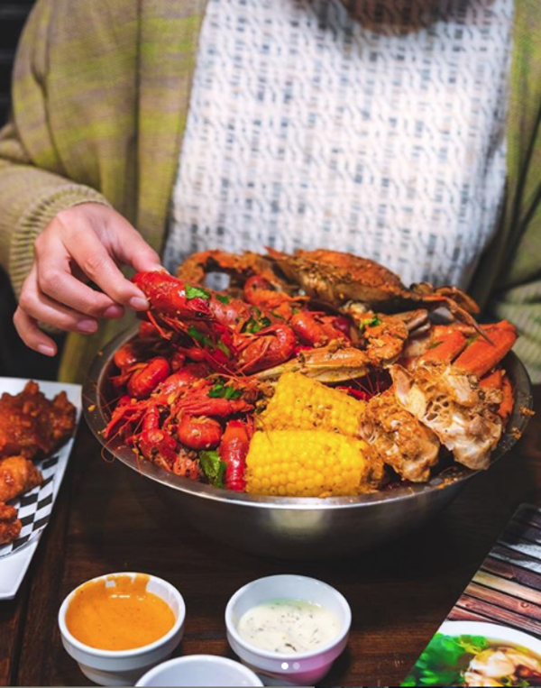 Enjoying a bowl of delicious crawfish.