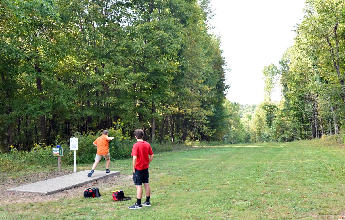 father and son playing disc golf