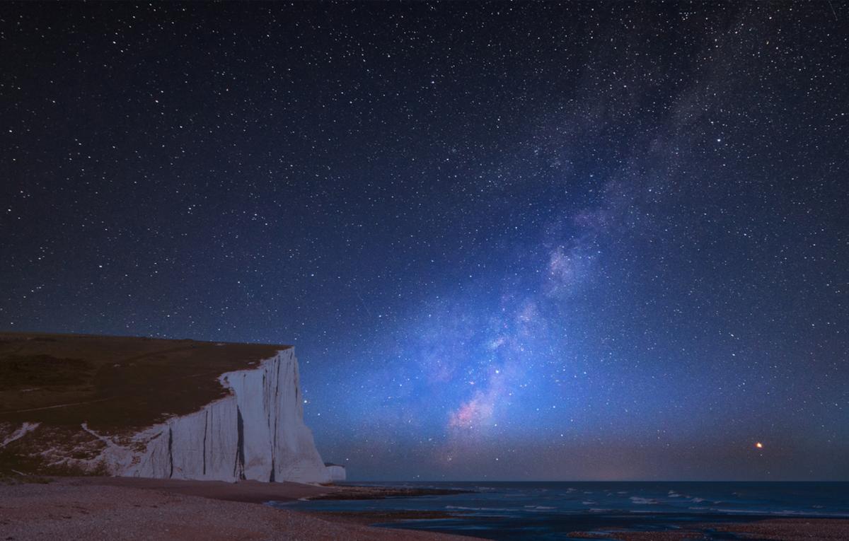 stargazing - milkyway visible at night in a dark skie over seven sisters cliffs