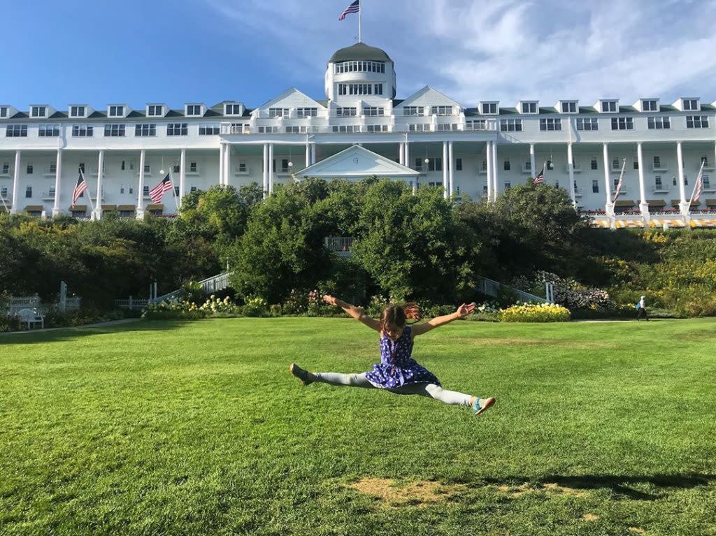 Young Girl Posing in Mid-Leap in Front of Grand Hotel on Mackinac Island