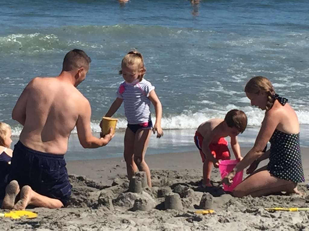Family Playing At Scarborough State Beach In Rhode Island