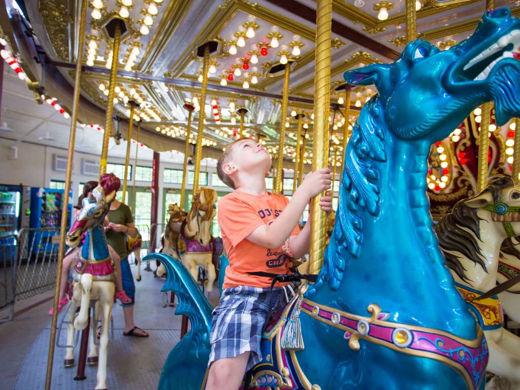 Riding the carousel at Roger Williams Park Zoo.