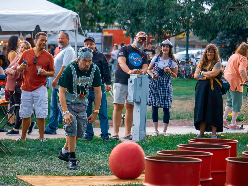 Man participating in giant beer pong with bystanders watching