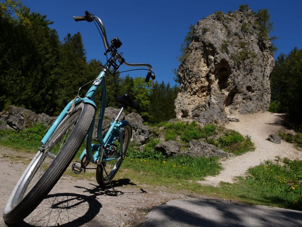 A bike stands on a dirt path near the Sugar Loaf rock formation in Mackinac Island State Park