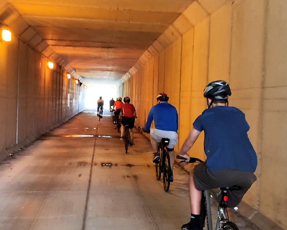 Riders traveling through one of two tunnels on the trail.