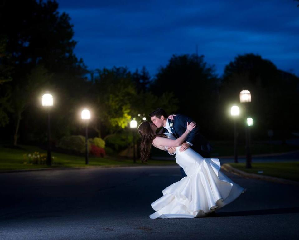 Wedding Couple Kissing in the Lit Driveway