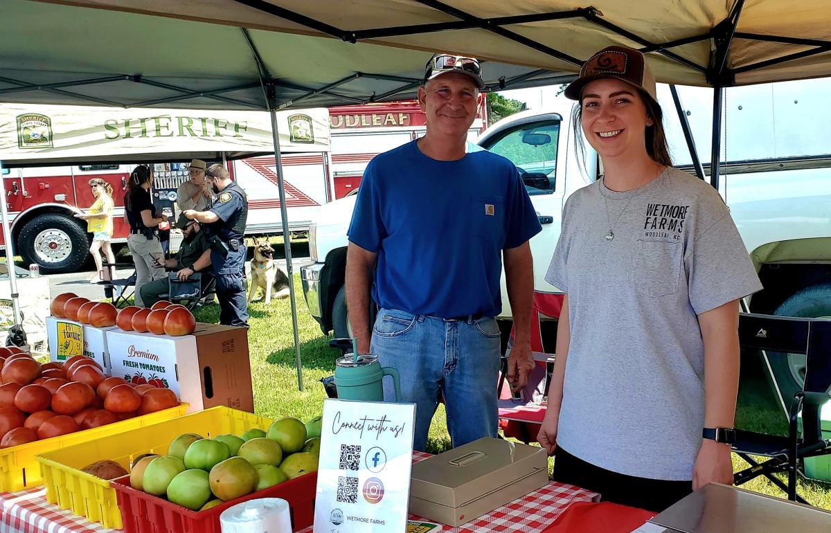 Two people at produce tent