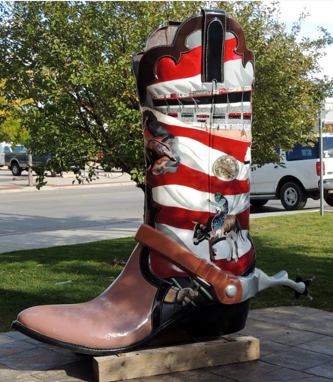 6' tall cowboy boot painted in patriotic red and white stripes with rodeo scenes.