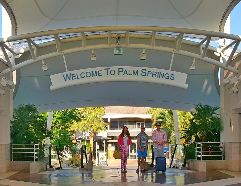 Three people walking to gate at PSP.
