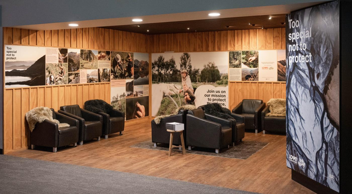 Queenstown Airport waiting nook decorated with information about the Love Queenstown initiative