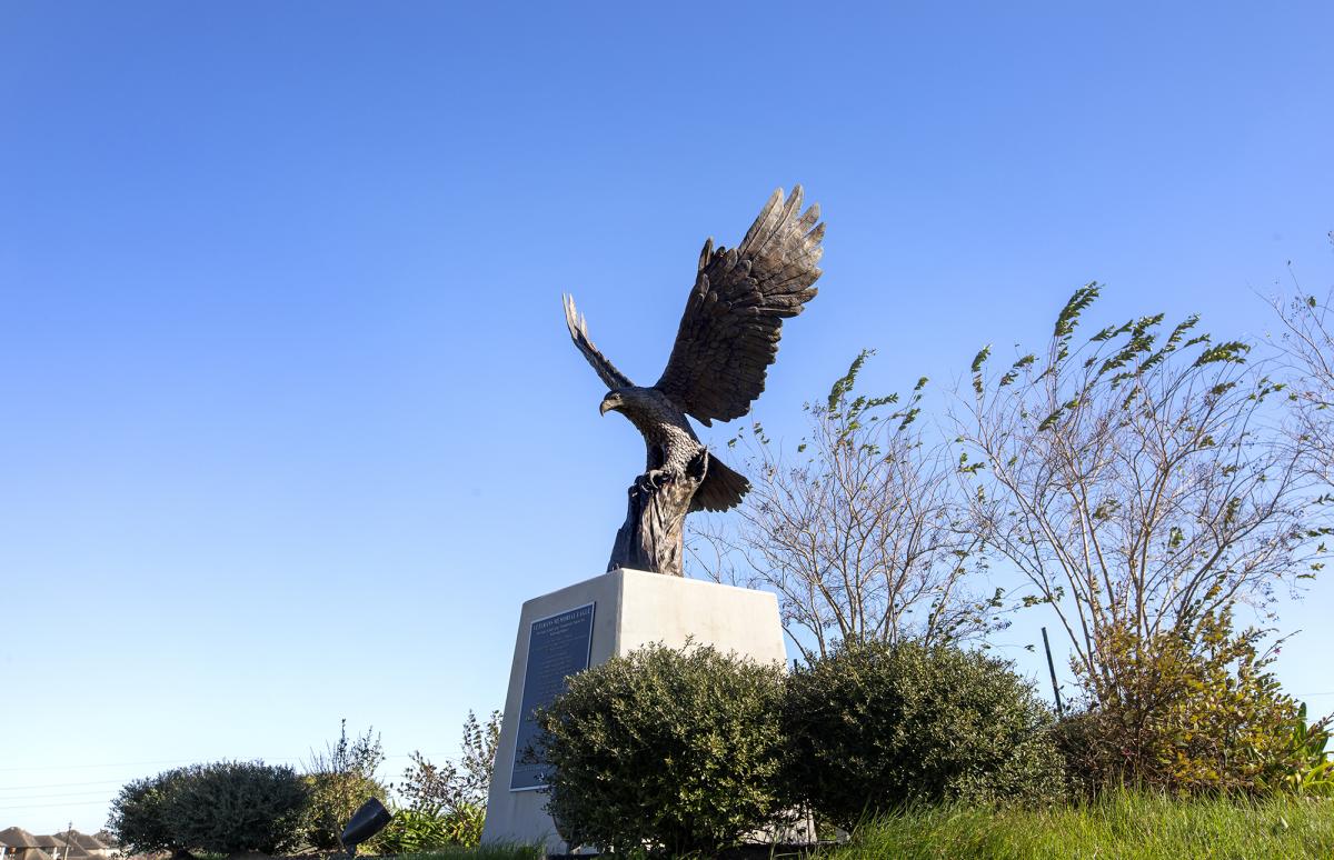 eagle statue surrounded by trees at sugar land memorial park