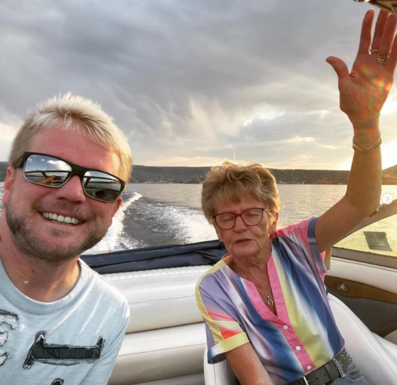 A man and a woman smiling on a boat in Alcova Lake