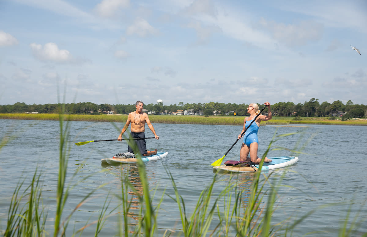 Couple paddleboarding in the inlet together