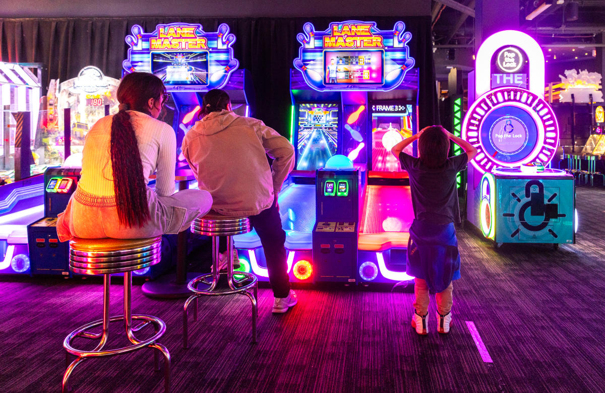 A Family Playing Lane Master in an Arcade