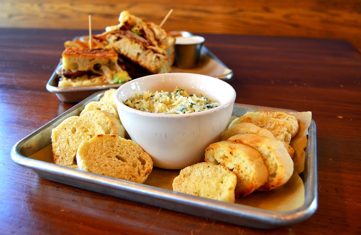 Bread & Bottle Princeton Appetizer Dip and Sandwich on Table.