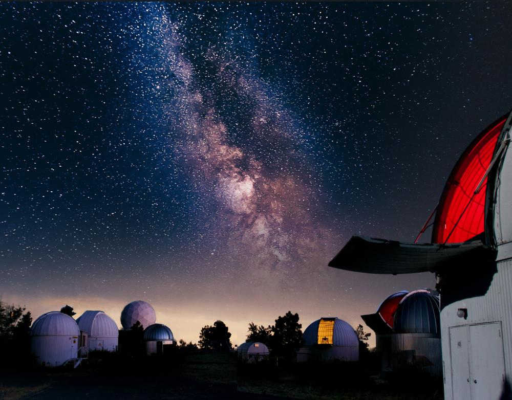 obervatories at UA SkyCenter on Mount Lemmon with a night sky filled with stars and the visible milky way