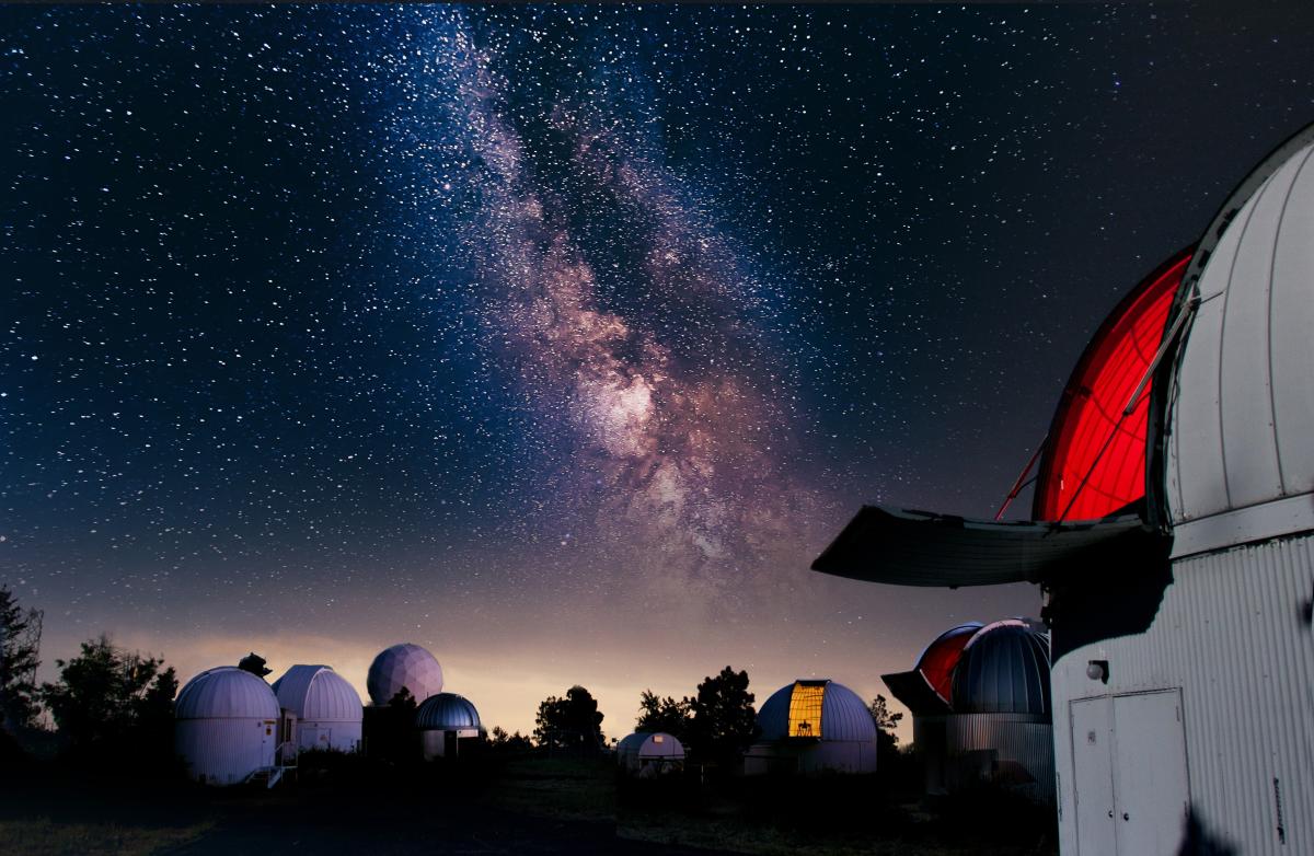 obervatories at UA SkyCenter on Mount Lemmon with a night sky filled with stars and the visible milky way