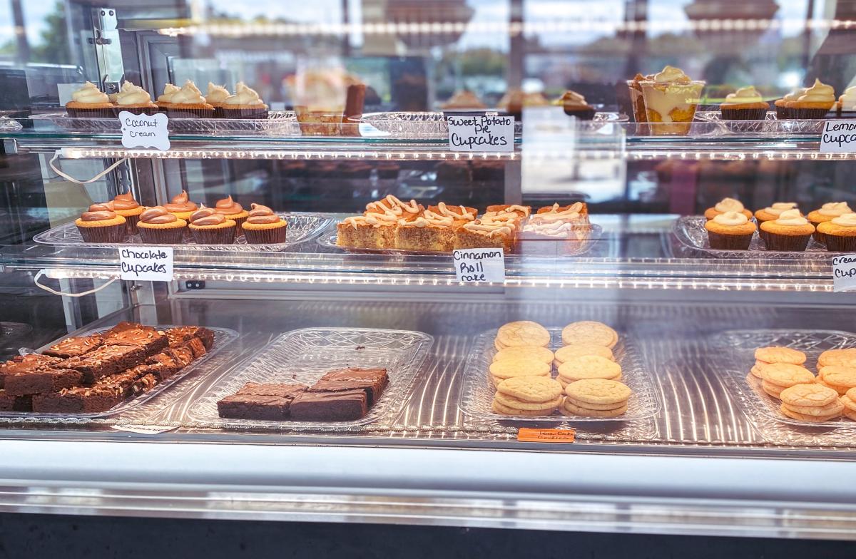 Glass case of desserts at Sweet P's Cupcakes Bakery.