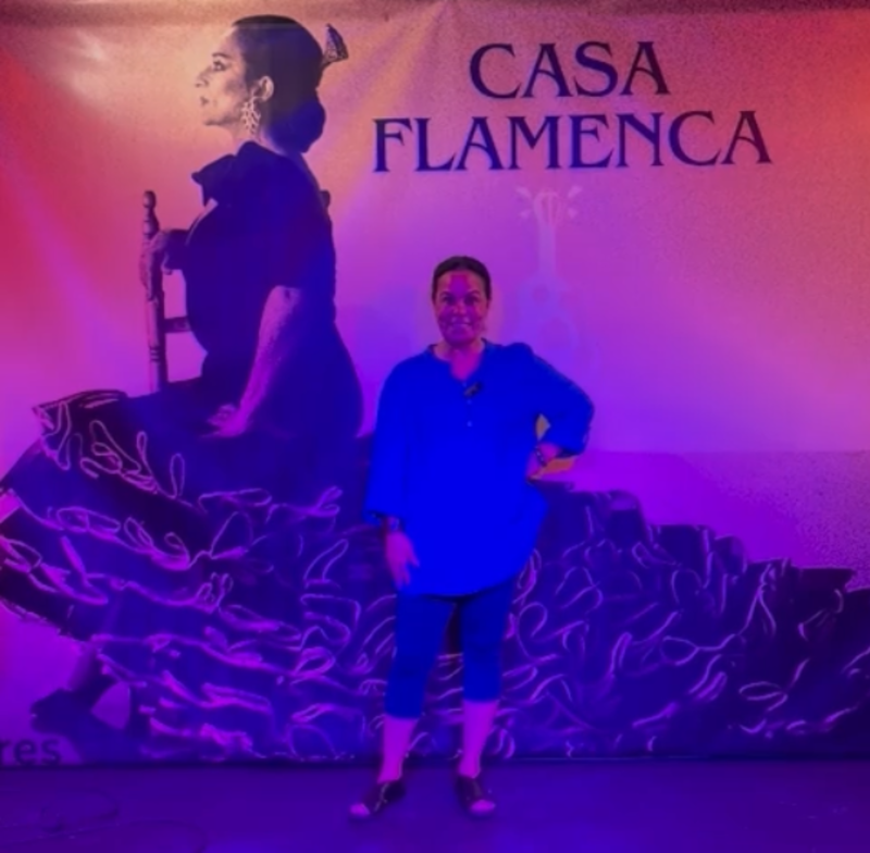 Carmen Montes stands in front of a Casa Flamenca sign.