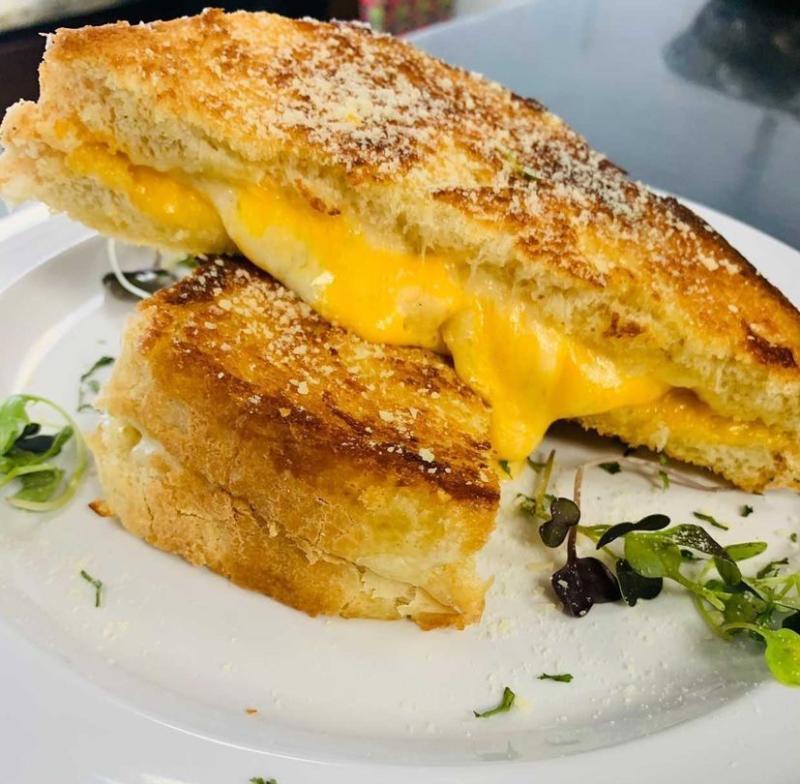 plated grilled cheese with dustings of greens