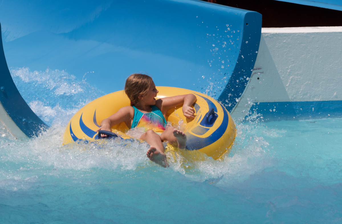 little girl in an inner tube sliding down the water slide at Point Mallard Water Park