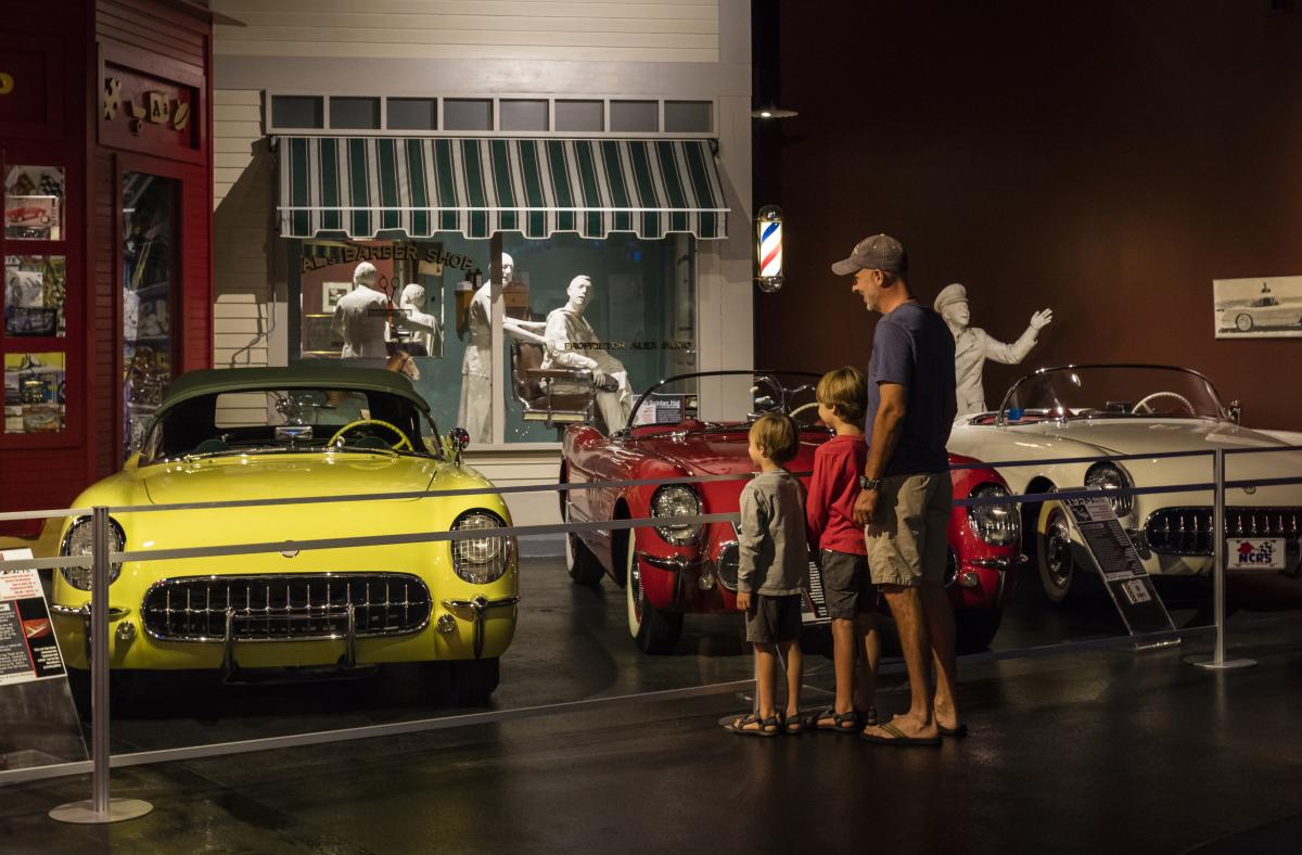 A father and sons look at cars at the National Corvette Museum in Bowling Green, KY