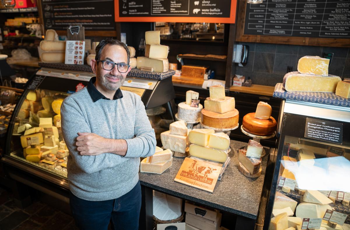 Ken Monteleone stands inside Fromagination Cheese Shop