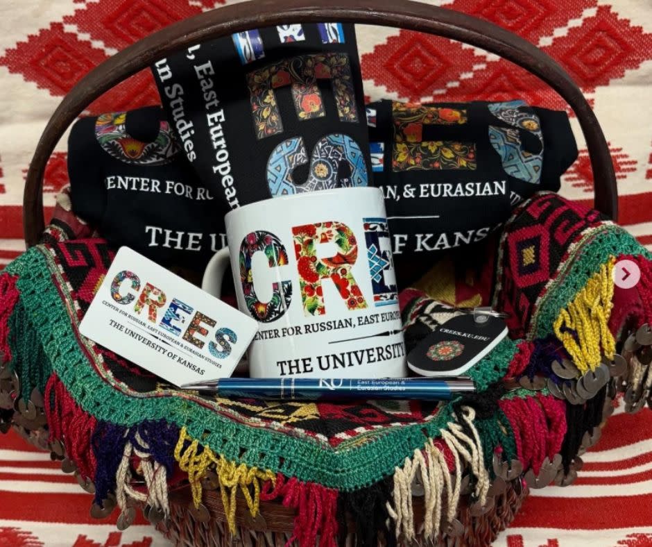Photo of a gift basket with free items branded with the KU Center for Russian, East European, and Eurasian studies' colorful logo.