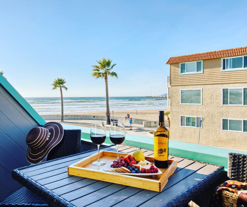 A balcony, with wine and snacks on the table, at the SeaVenture Hotel over looking the ocean