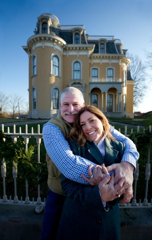 Couple in a hugging pose in front of Culbertson Mansion