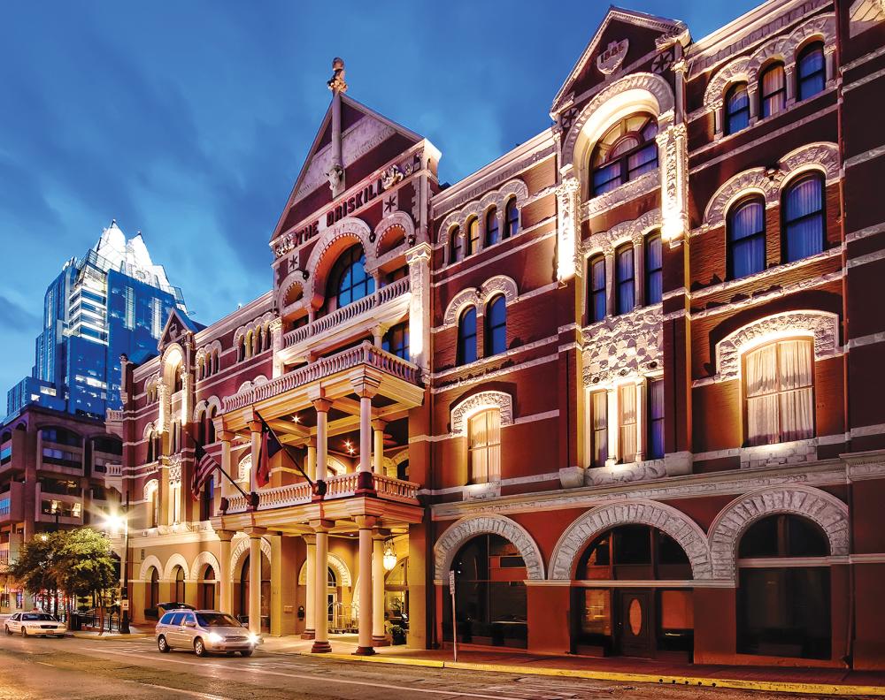 The Driskill Hotel exterior at sunset with frost bank tower behind