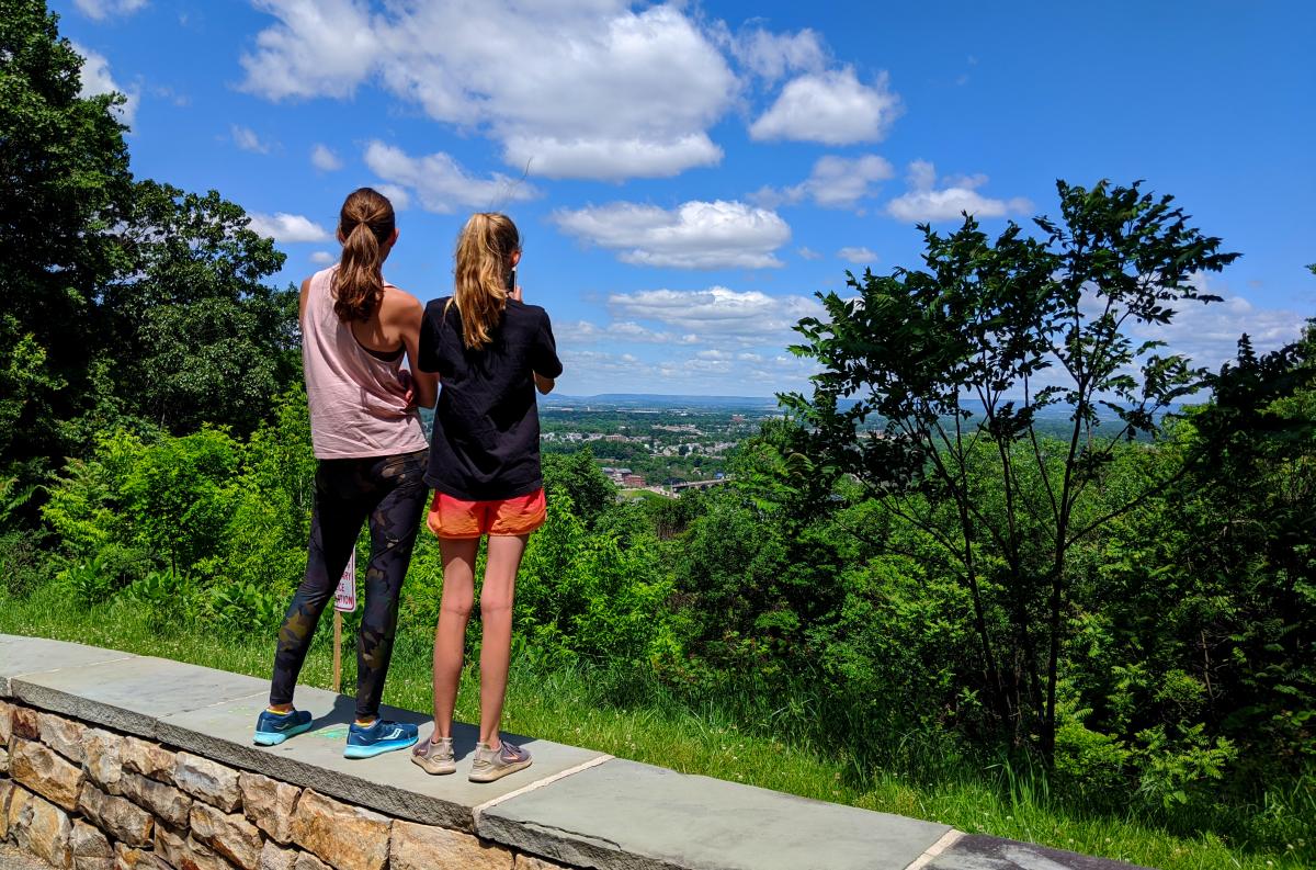 Two people take in the view at Lehigh lookout on South Mountain in Bethlehem, PA