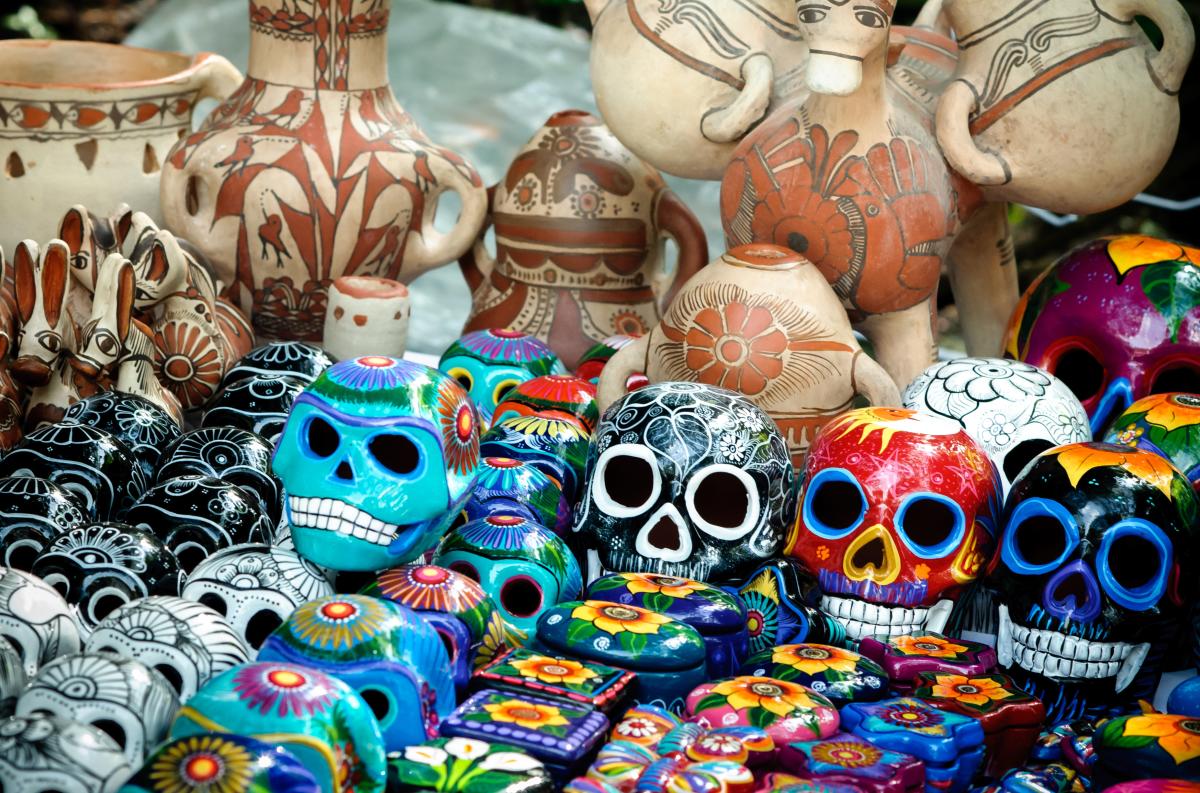 Traditional mexican day of the dead souvenir ceramic skulls at market stall