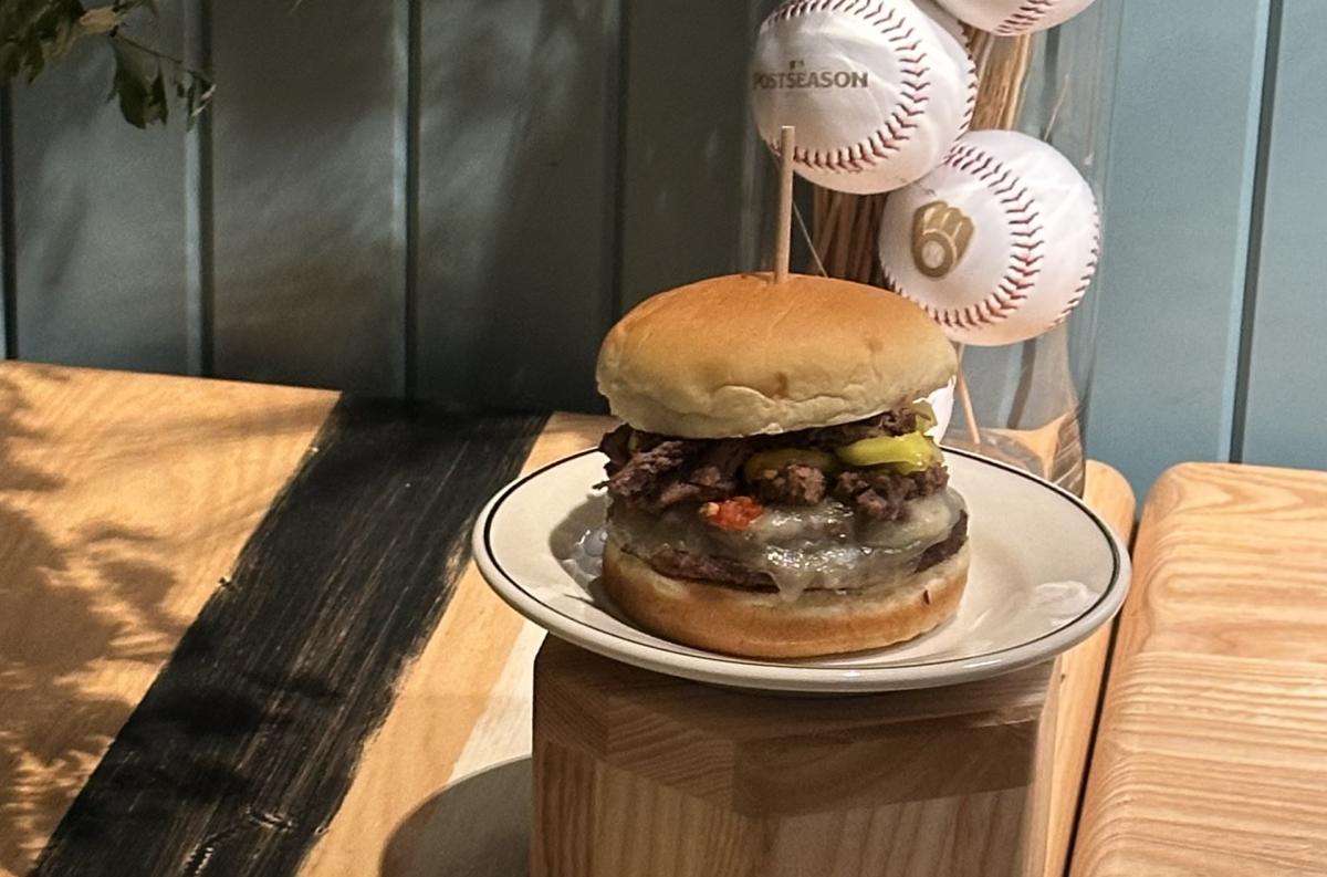 The Big Chew Burger, displayed with Milwaukee Brewers postseason baseballs and floral decorations.