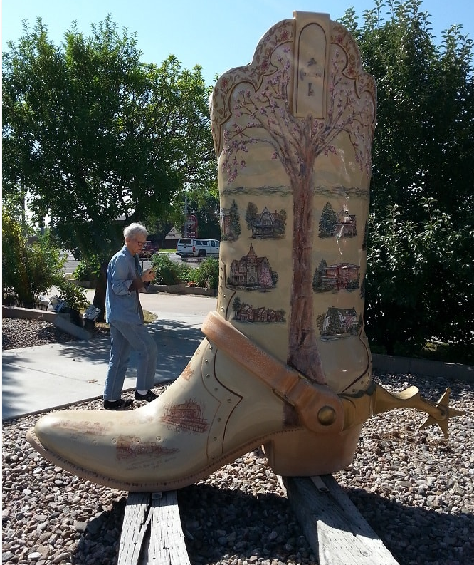 ^' tall cowbot boot with trees and buildings painted on the sides.