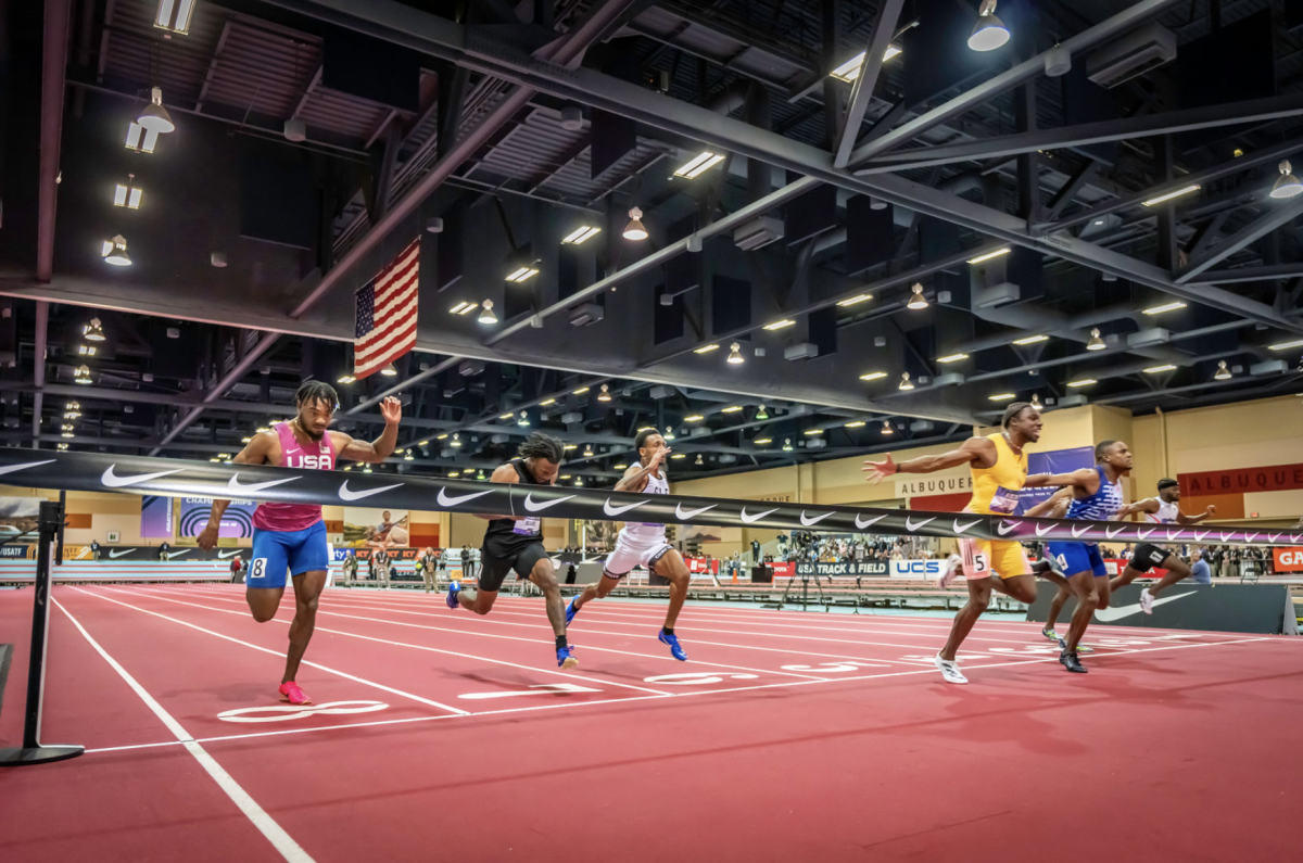 Male runners competing in an event cross the finish line at the 2024 USATF Indoor Championships