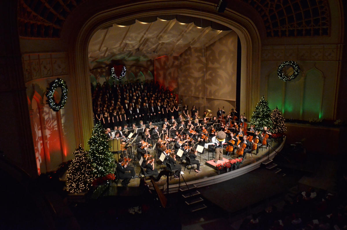An orchestra on stage performing a holiday concert at the University of Colorado.