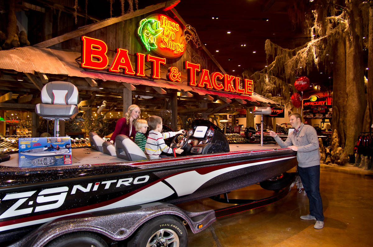 Family playing in boat at Bass Pro Shops