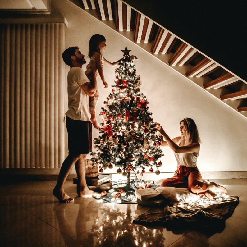 Family decorating Christmas Tree