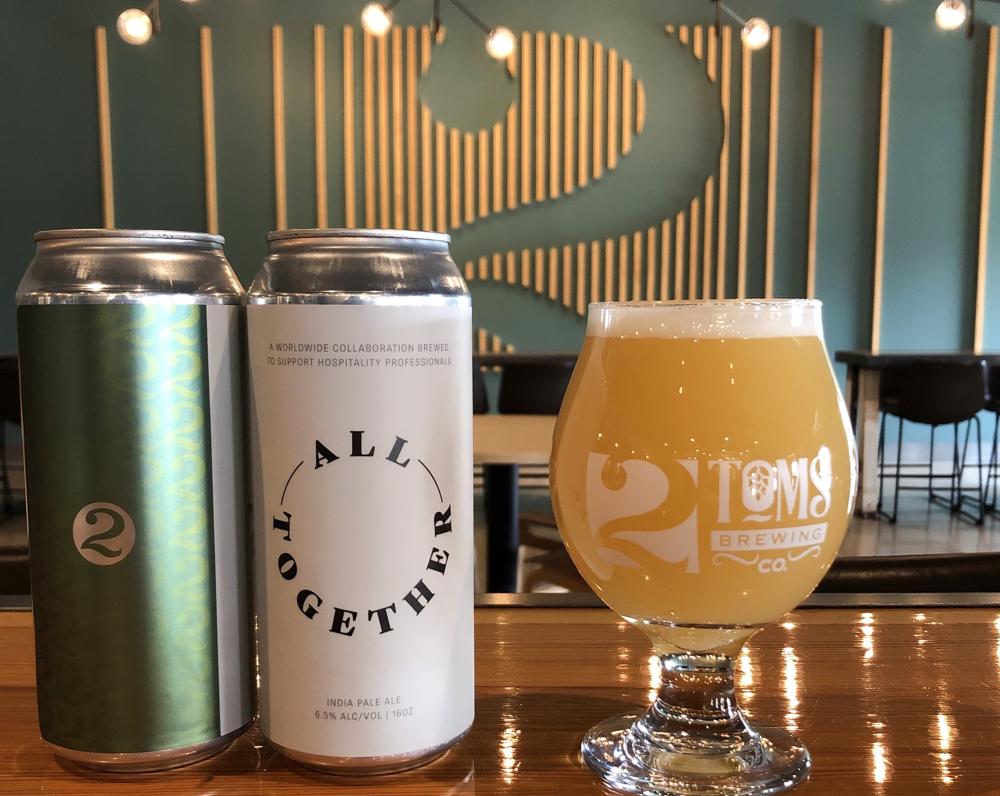 Two cans and a glass of the All Together IPA from 2Toms Brewing Company in Fort Wayne