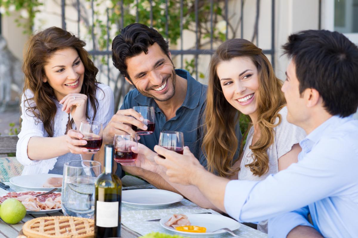 friends cheersing wine glasses at a wine tasting