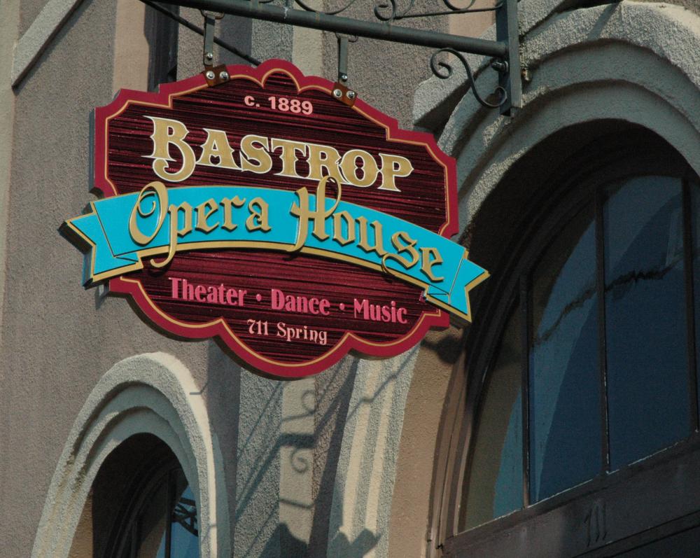 A Business Sign in Front of The Bastrop Opera House
