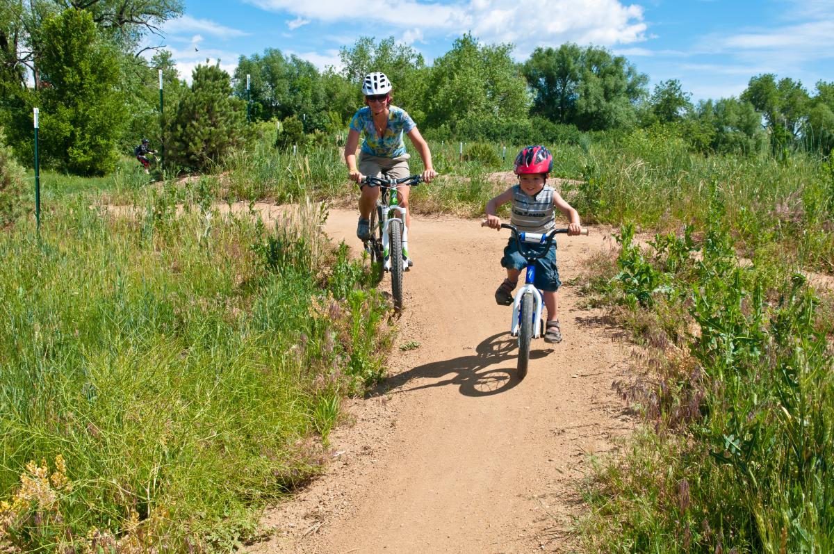 Man And Child Biking On A Valmont Bike Trail