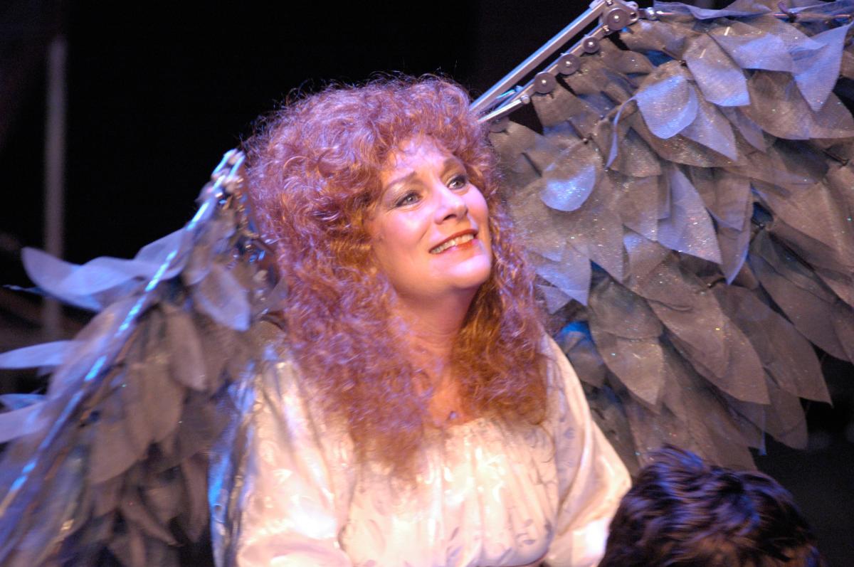 A woman in an angel costume during a Bas Bleu performance